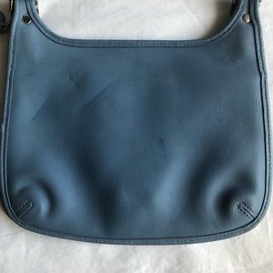 Dark baby blue crossbody coach bag.